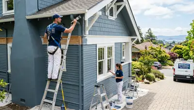 Professional house painters in Oakland, CA applying fresh exterior paint to a residential home