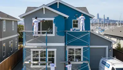 Professional house painters working on residential exterior in Oakland, CA