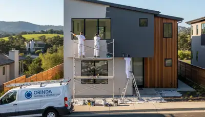 Professional house painters working on residential exterior in Oakland, CA