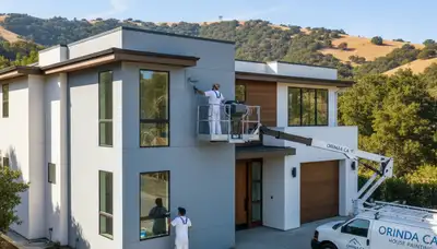 Professional house painters working on residential exterior in Oakland, CA